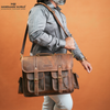 Handmade World Leather bag for men hold by the model in grey shirt on one side of his shoulder with shoulder strap
